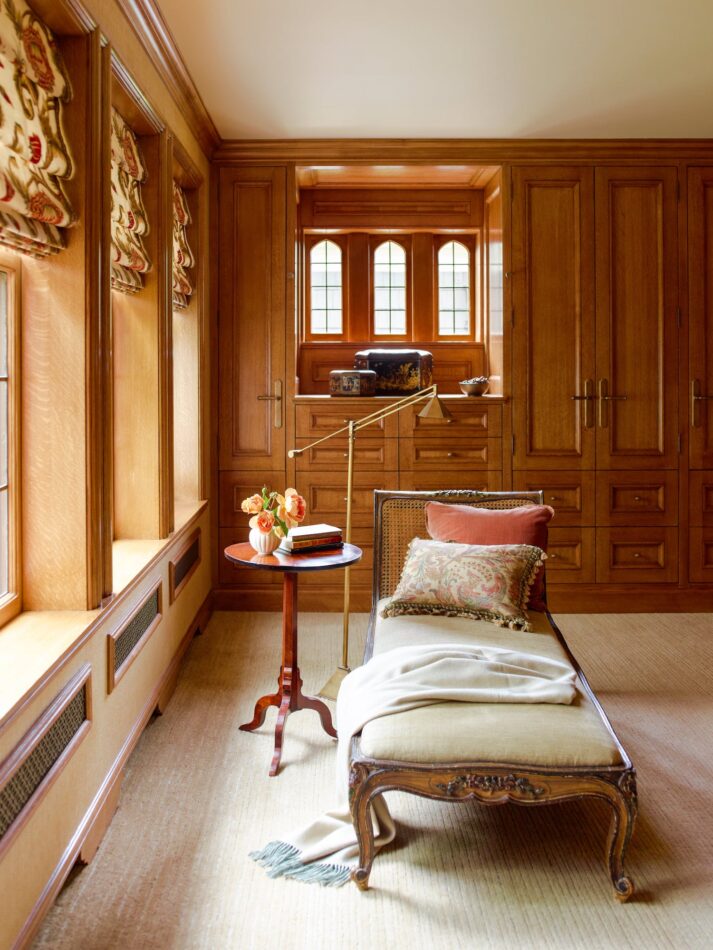 closet with a day bed and wood paneled walls
