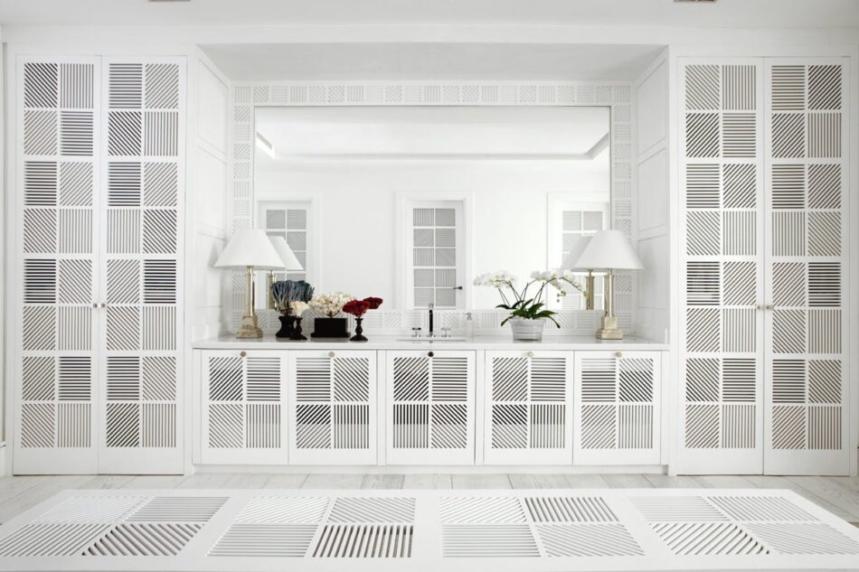 A white closet with latticed cabinets and floors