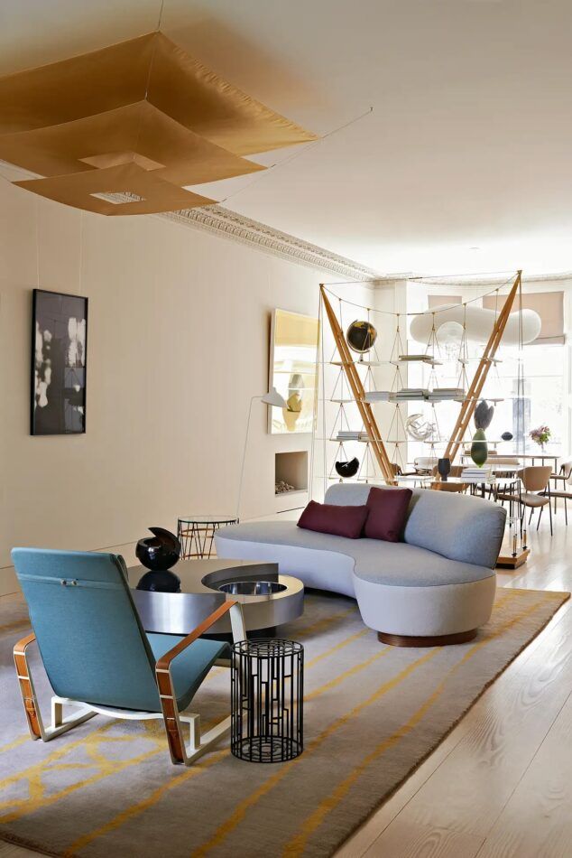 The great room of a London home by Waldo Works combines living and dining spaces, separated by Franco Albini’s Veliero bookcase.