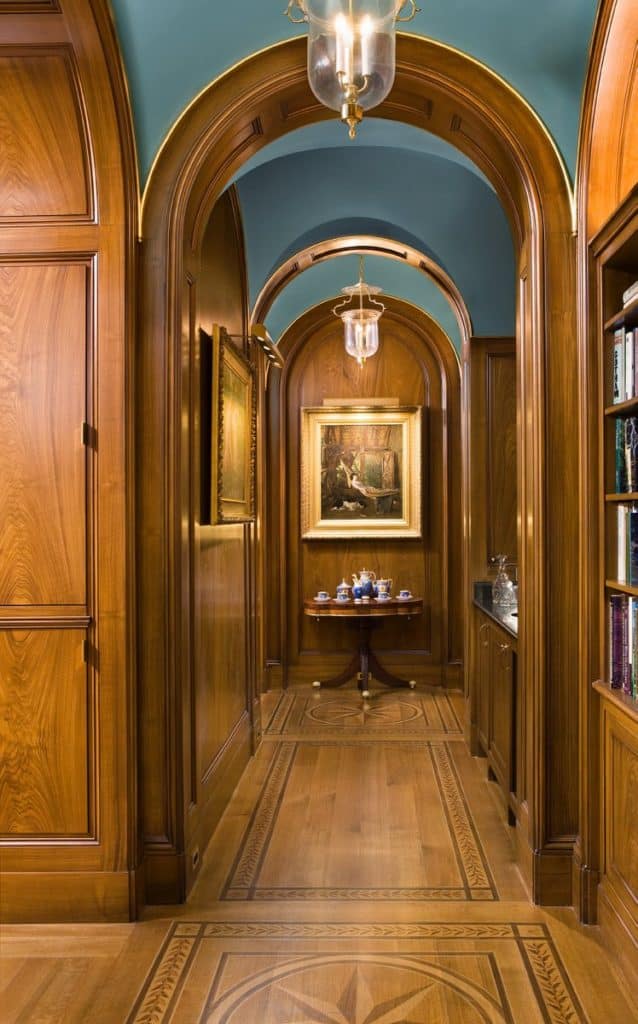 In this Peter Pennoyer–designed home in Dutchess County, New York, the library has wood-paneled walls and flooring.