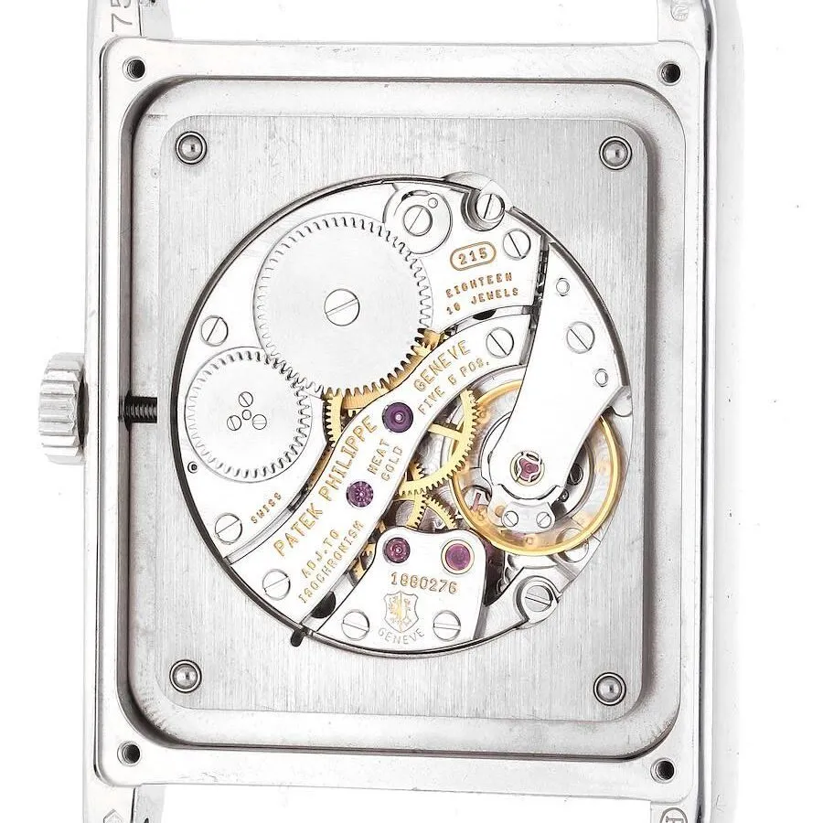 The back of a white-gold Patek Philippe watch displays the components of the watch and the Geneva Seal.